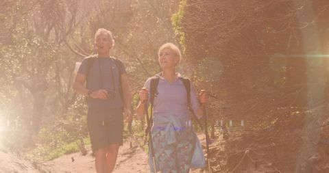 Senior Couple Enjoying Hike in Sunlit Countryside