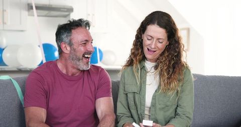 Happy Couple Celebrating with Gift Exchange on Birthday