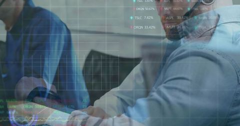 Manager reviewing data on laptop with team during business meeting with analytics overlay & charts
