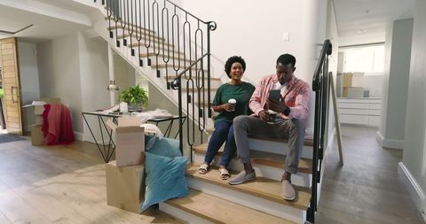 Happy Couple Unpacking Boxes in New Home