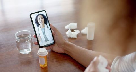 Person using smartphone for telemedicine with doctor