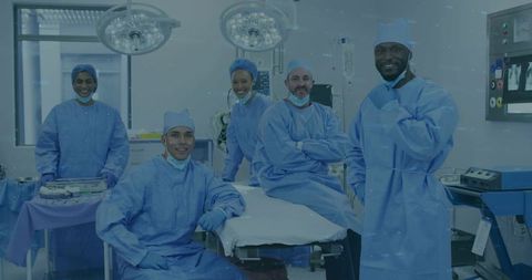 Multicultural surgical team standing around operating table in modern operating room