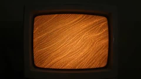 Vintage CRT Displaying Orange Wave Pattern Loop, Retro Ambient Monitor Glow