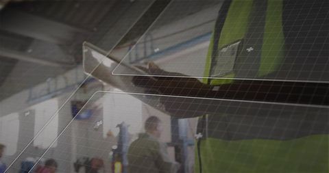 Technician using tablet in industrial hallway