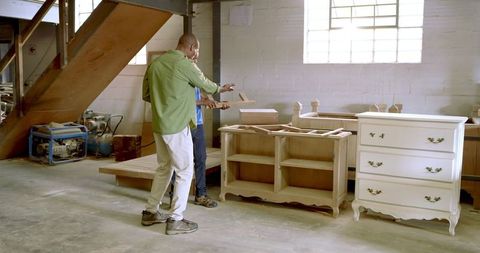 Skilled Carpenters in Workshop Preparing Dresser Frame