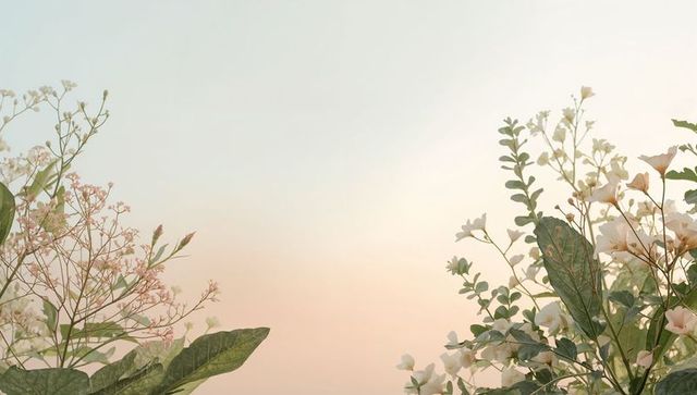 Framing pastel garden border with delicate white and pink blooms against soft sunrise sky