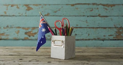 Australian Flag with School Supplies on Rustic Wooden Table