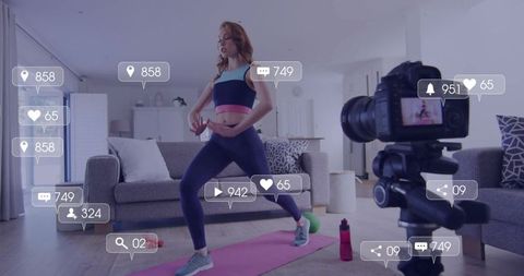Female fitness instructor recording home workout with DSLR, social media engagement