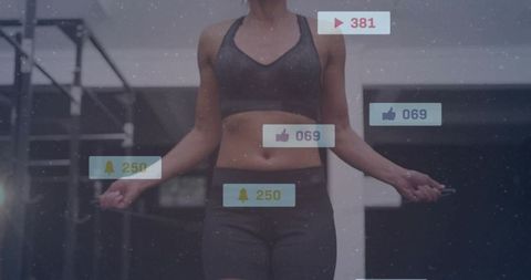 Fit Woman Jumping Rope in Modern Gym with Social Media Notifications