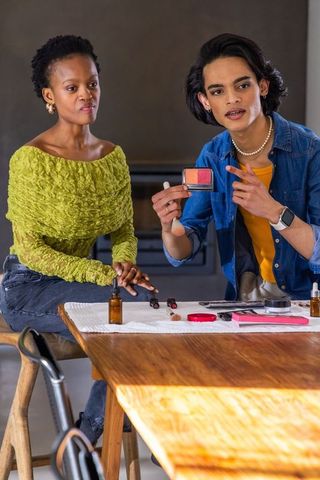 Makeup artist demonstrating dual-shade blush palette during client consultation