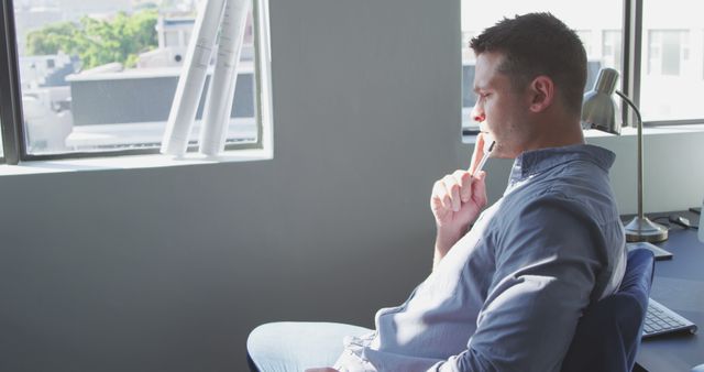 Thoughtful Man Sitting by Window Considering Ideas - Download Free Stock Images Pikwizard.com