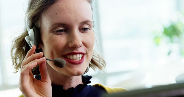 Smiling female customer service executive working in call center