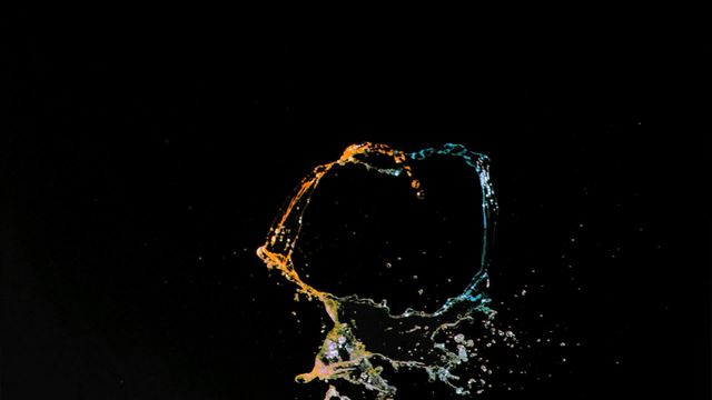 Vibrant water splash against a crisp black background captures the beauty of liquid in motion. Perfect for use in design projects highlighting concepts of fluidity and energy. Useful for educational materials focusing on physics and motion. Also ideal for creative digital backdrops in advertisements or art projects.