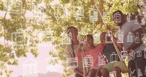 Sunlit family swinging under leafy tree with digital icons for finance and wellbeing