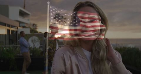 Woman enjoying sunset on rooftop with us flag overlay