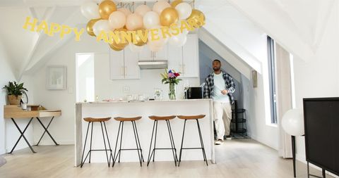 Couple tidying up after anniversary celebration at home