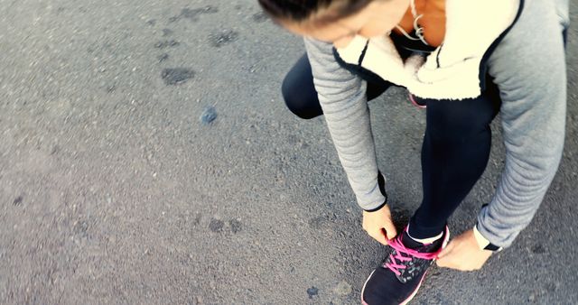 Woman Tying Shoelaces Before Outdoor Exercise - Download Free Stock Images Pikwizard.com