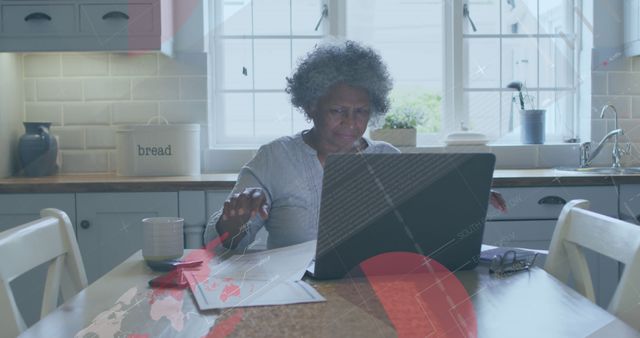 Elderly Woman Using Laptop at Home Kitchen Table - Download Free Stock Images Pikwizard.com