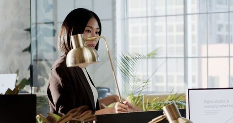 African American Woman Holds Tablet Confidently in Modern Office