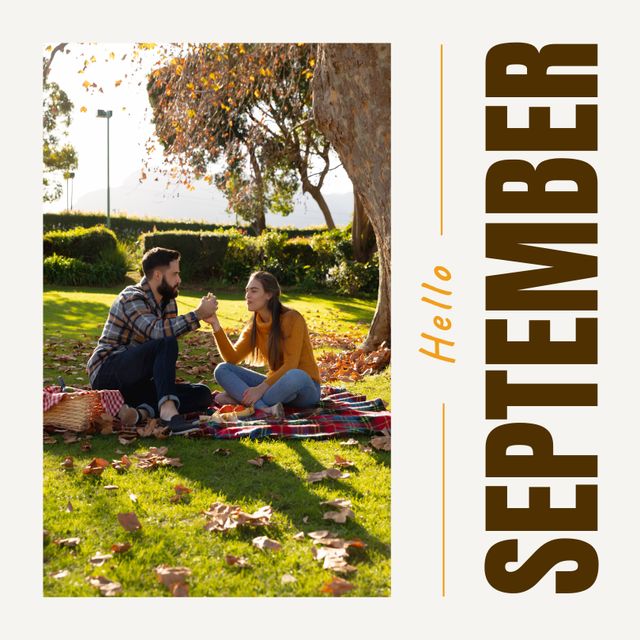 Couple enjoying an outdoor picnic in a park during September, surrounded by fallen leaves. Ideal for themes of autumn, romance, leisure activities, and outdoors. Great for greeting cards, seasonal promotions, and lifestyle blogs.