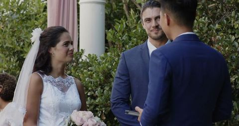 Bride and groom smiling during outdoor wedding ceremony