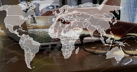 Typing hands on laptop with world map overlay connecting global remote workflows