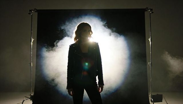 Backlit silhouette model wearing leather jacket with halo smoke and dramatic rim light