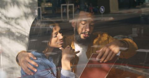 Candid Moment Shared by Biracial Couple in Contemporary Cafe