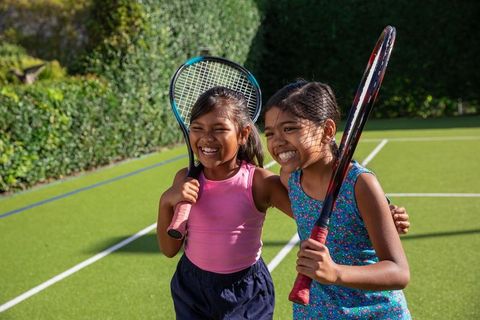 Happy Children Enjoying Tennis on Sunny Day