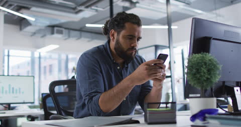 Professional in Modern Office Engaged with Smartphone