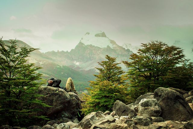 Hiker Relaxing Amid Mountainous Landscape with Snow Cap - Download Free Stock Photos Pikwizard.com