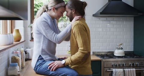 Caucasian Couple Embracing in Cozy Kitchen Setting
