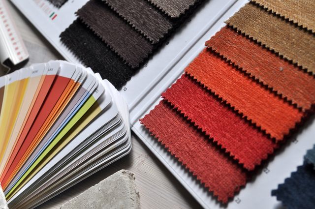 Vibrant collection of fabric swatches next to color palette guide, ideal for interior design projects, decorating ideas, and color coordination. Great for designers and decorators seeking inspiration for color matching and textural options in home or office spaces.