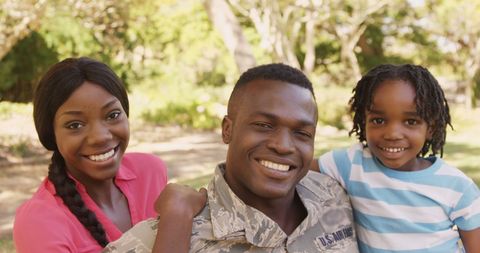 Proud Military Family Smiling in Open Park Setting - Download Free Stock Images Pikwizard.com