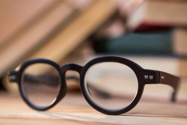 Close-up of spectacles on a wooden table