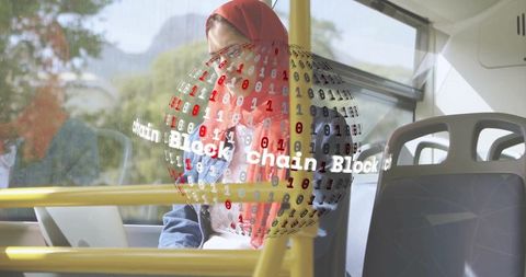 Woman wearing red hijab working on laptop during transit with blockchain hologram