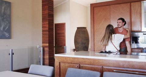 Happy Couple Embracing in New Kitchen, Celebrating Home