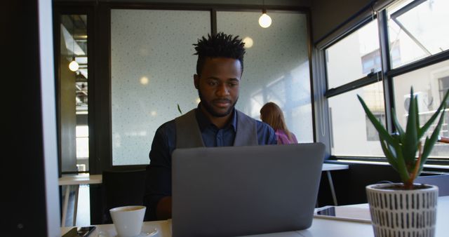 Focused Young Black Businessman Working on Laptop in Office Environment - Download Free Stock Images Pikwizard.com