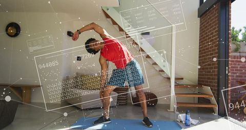 Man performing lateral stretch with augmented reality fitness hud in modern home