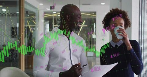 Professionals in Smart Casual Discussing Digital Data in Modern Office