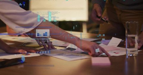 Hands Analyzing Data Charts in Collaborative Office Environment