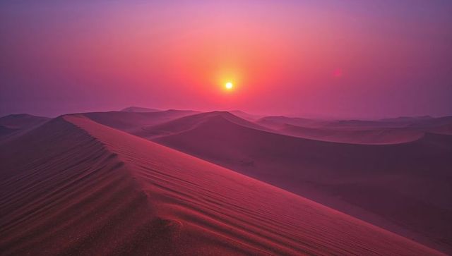 Serene Pink Sunset Over Majestic Desert Dunes