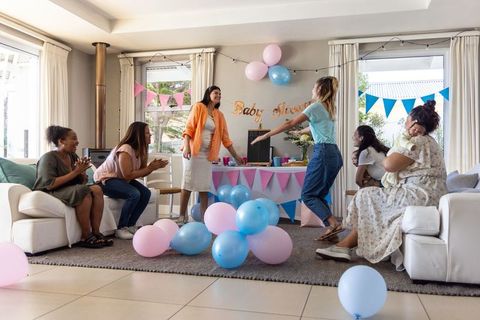 Diverse group of friends celebrating joyful baby shower at home