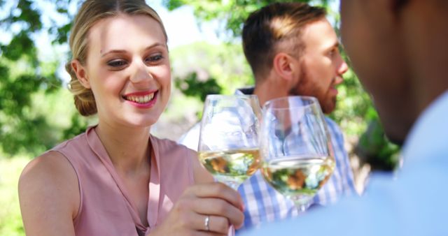 Happy friends toasting glasses of wine at restaurant