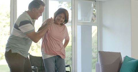 Senior couple smiling and clapping together at home