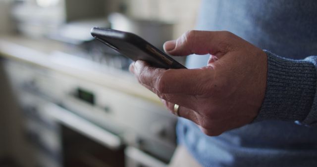 Close Up of Mature Hand Using Smartphone by Kitchen Counter - Download Free Stock Images Pikwizard.com