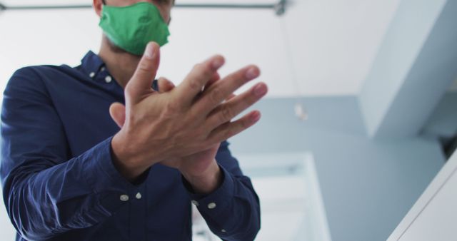 Man Wearing Face Mask Sanitizing Hands - Download Free Stock Images Pikwizard.com