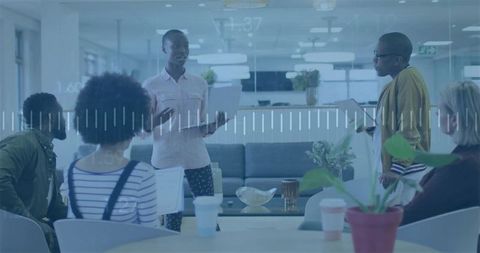 Diverse Team Brainstorming in Modern Office Lounge with Technology