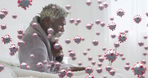 Senior Man Using Laptop Surrounded by Virtual Virus Cells