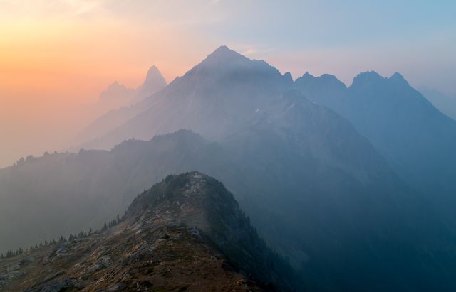 Majestic Mountain Range at Sunrise with Misty Peaks - Download Free Stock Photos Pikwizard.com